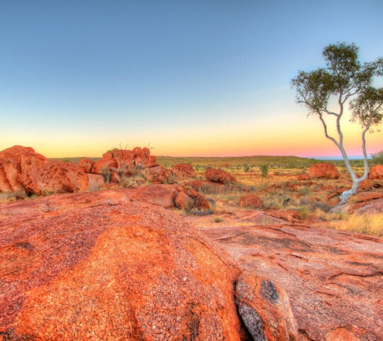 The Karlu Karlu Devils Marbles granite formations in the Northern Territory at sunset.