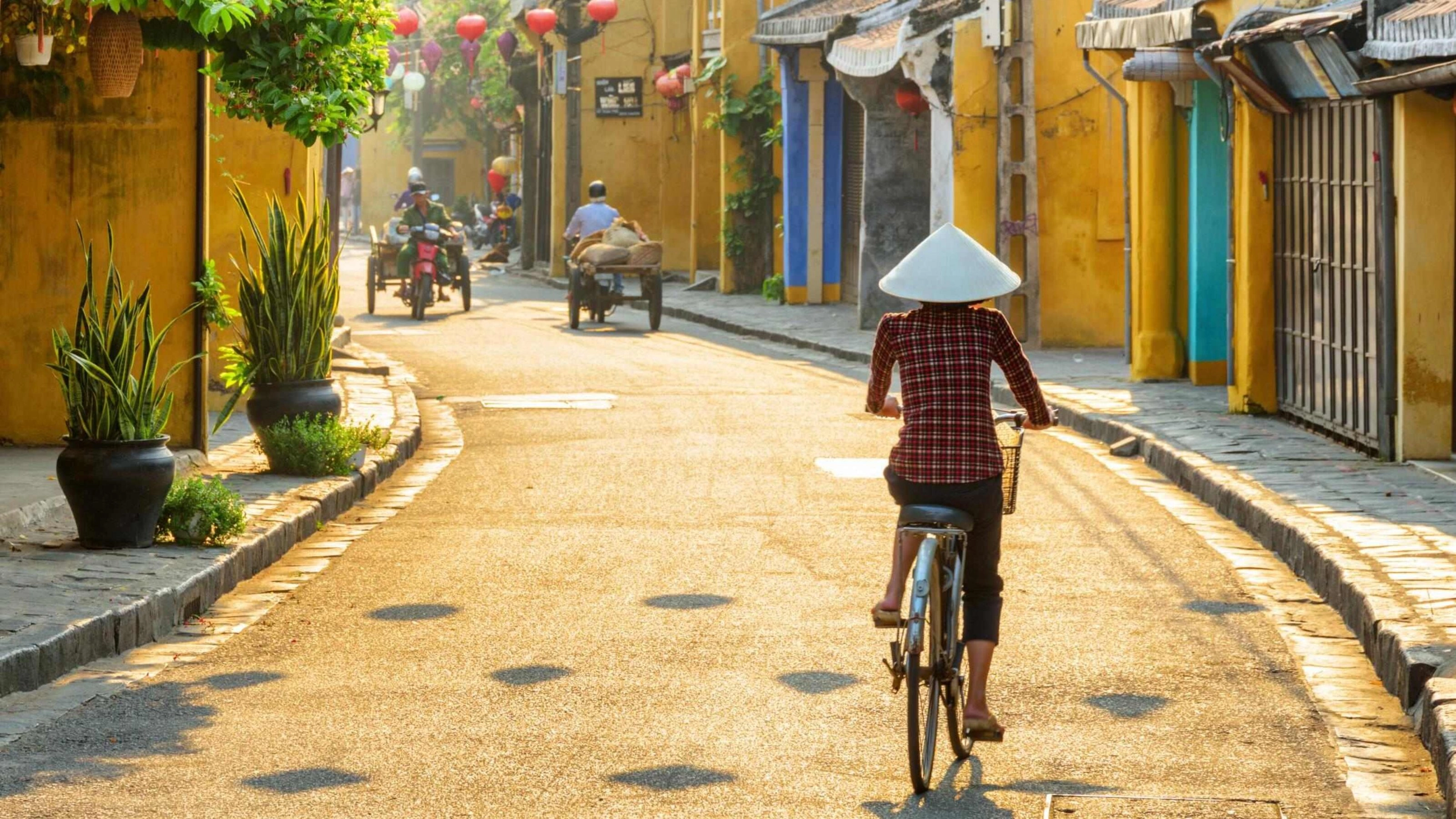Woman cycling in Hoi An in Vietnam