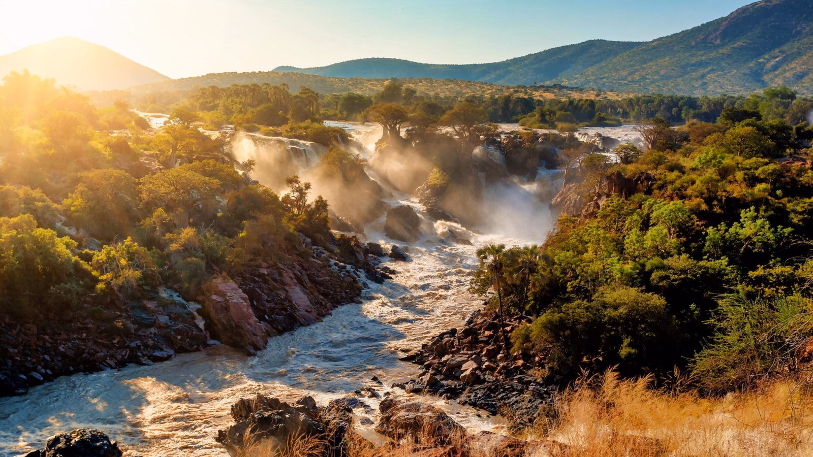Sun shines on Epupa Falls on the Kunene River in Namibia