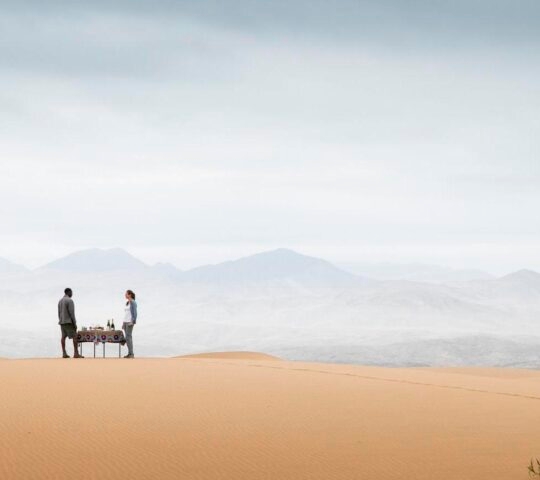 Sundowners in the sand dunes from Wilderness Serra Cafema, looking out onto the horizon
