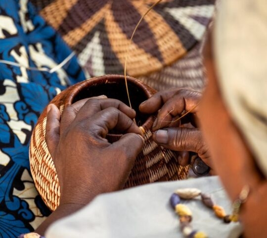 Detailed view of a person weaving a traditional basket on Namibia and Botswana Luxury Tours.