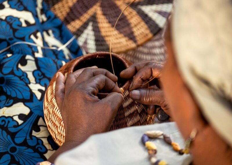 Detailed view of a person weaving a traditional basket on Namibia and Botswana Luxury Tours.