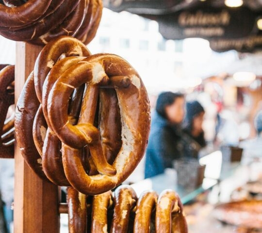 Traditional pretzels called Brezel hang on the stand