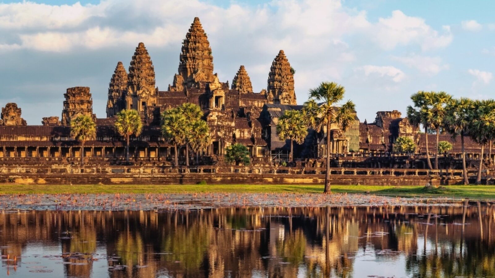 Angkor Wat temple complex reflected in a pond during luxury Asia grand tours.