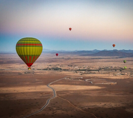 Hot air balloons float above Marrakech, Morocco,