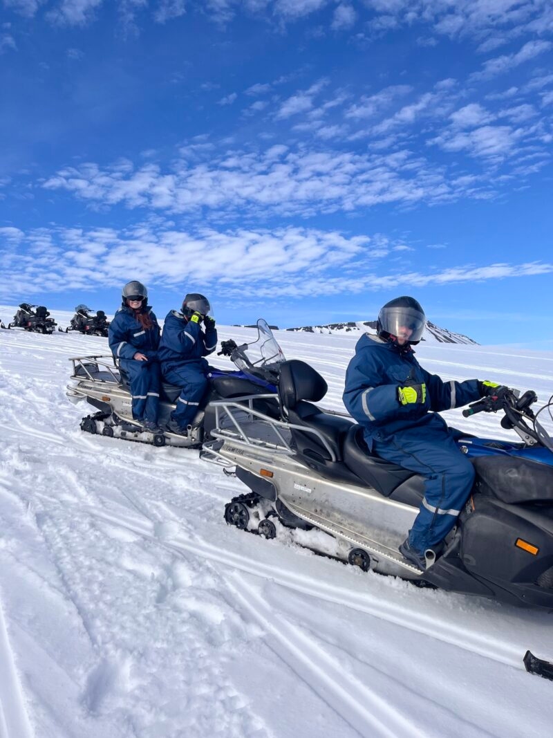 people on snowmobiles