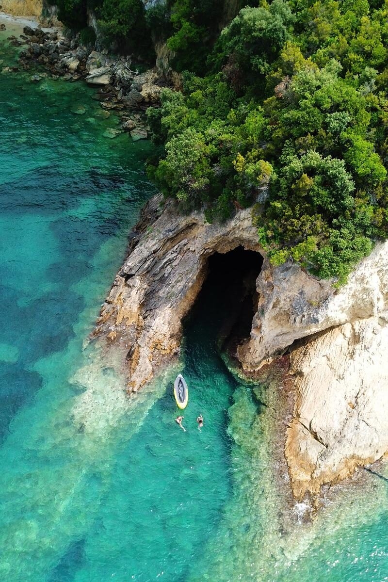 Aerial drone bird's eye view photo of famous caves in Sivota area, Epirus, Greece