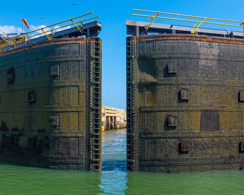 A huge metal lock gate swinging open on the Panama Canal