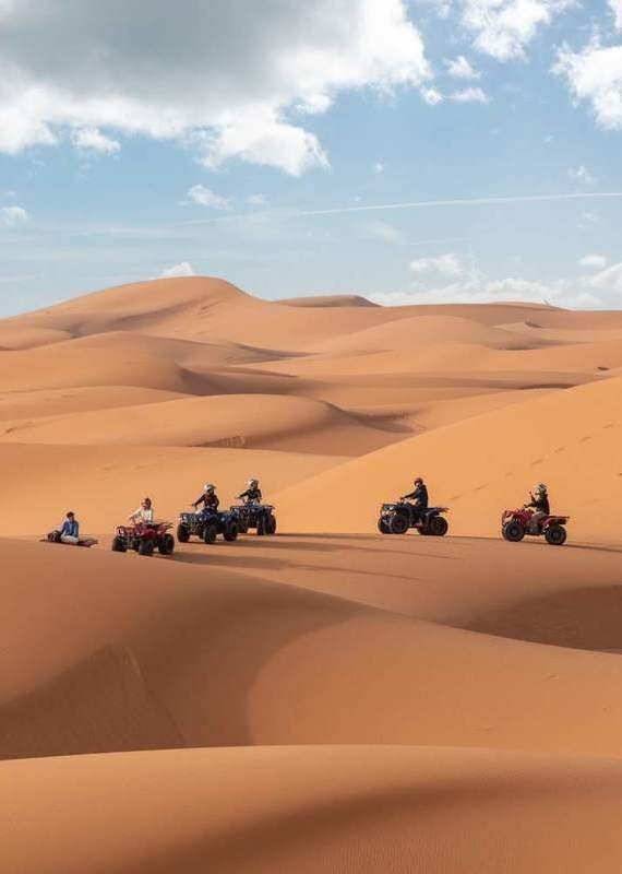 Motorbikers driving off-road in the Erg Chebbi desert near Merzouga, Morocco Motorbikers driving off-road in the Erg Chebbi desert near Merzouga in Morocco desert