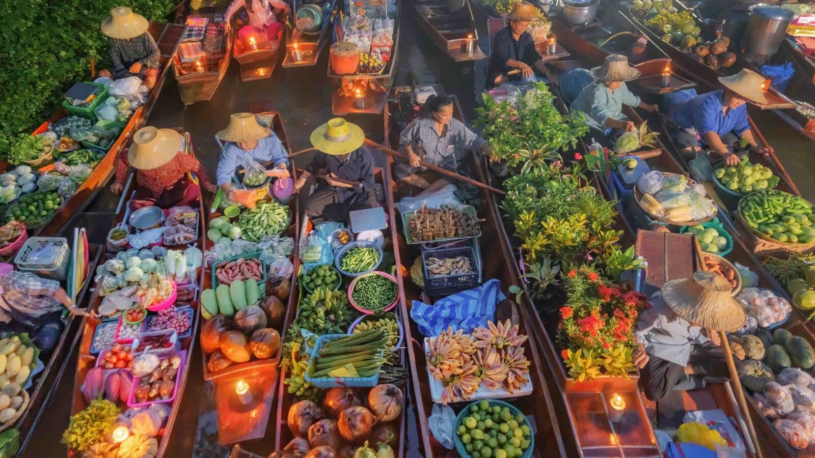 Damnoen Saduak Floating Market or Amphawa. Local people sell fruits, traditional food on boats in canal, Ratchaburi District, Thailand.
