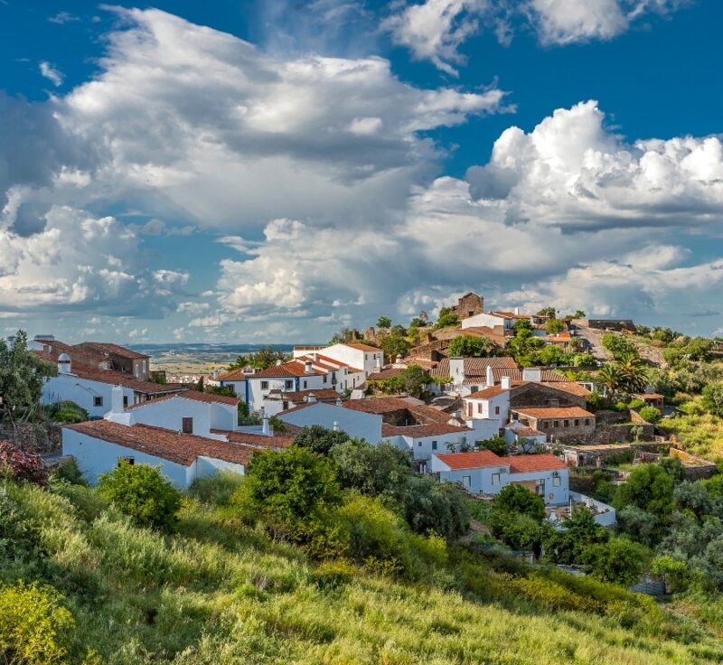 Portugal , the District of Evora . Immersed in the green village of Monsaraz outside walls. Bright , sunny spring day , beautiful clouds .