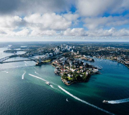 Aerial view of Sydney Harbour, with the Harbour Bridge and ferries in the water