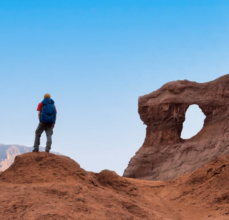 Hiker with backpack enjoy the landscape on deserted mountains - The Window in the Rock (Las Ventanas in spanish) in Cafayate, Salta, Argentina