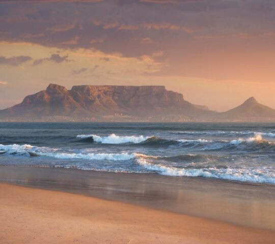 Sunset on a beach near Cape Town, with Table Mountain in the background