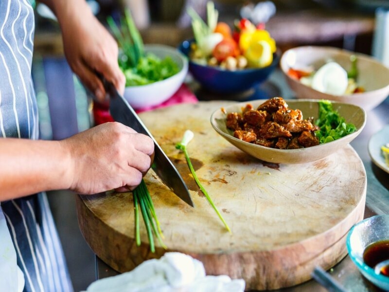 Chef making traditional cambodian meat dish at cooking class