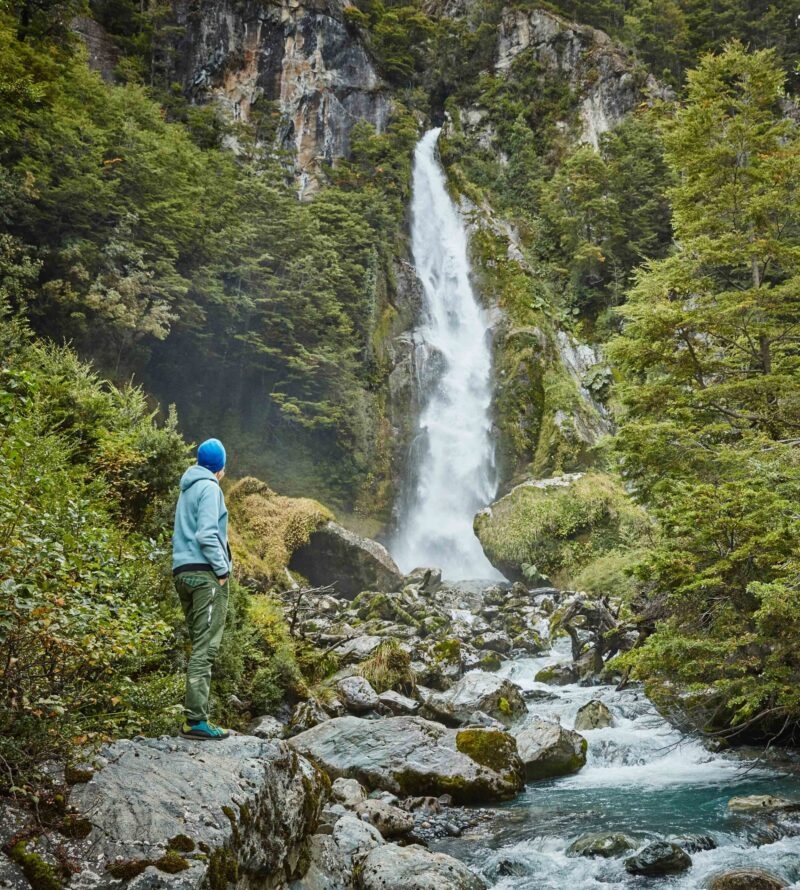 Chile, Laguna San Rafael National Park, woman admiring Las Cascadas waterfall