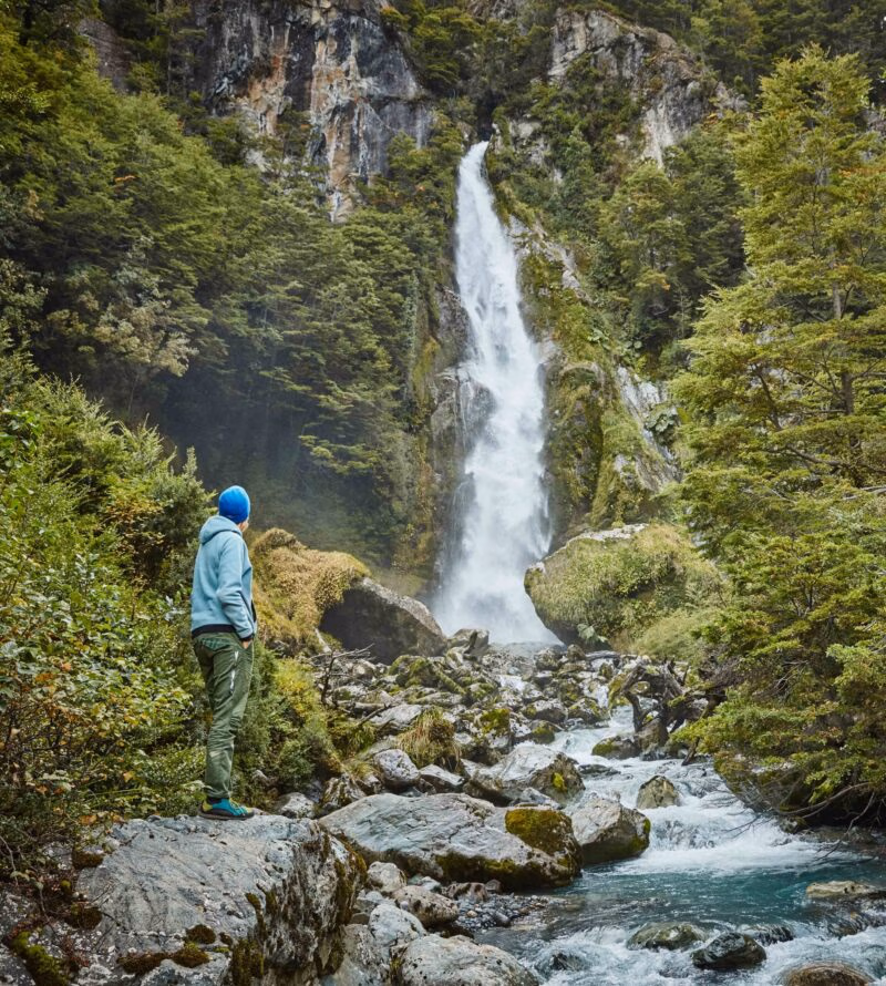 Chile, Laguna San Rafael National Park, woman admiring Las Cascadas waterfall