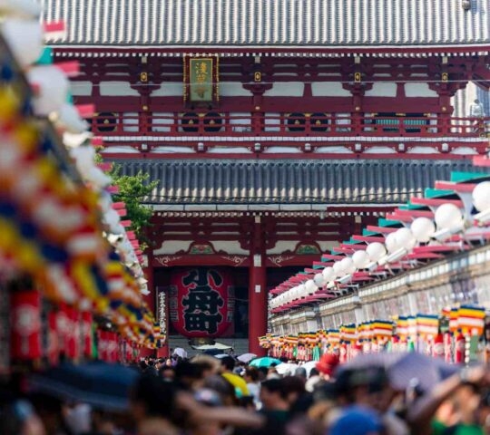Crowds of people in Nakamise Dori Street leading towards the Senso-ji temple in Tokyo, Japan