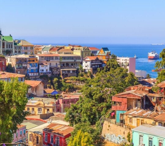 A view of the colourful streets of Valparaiso in Chile, with the ocean in the background