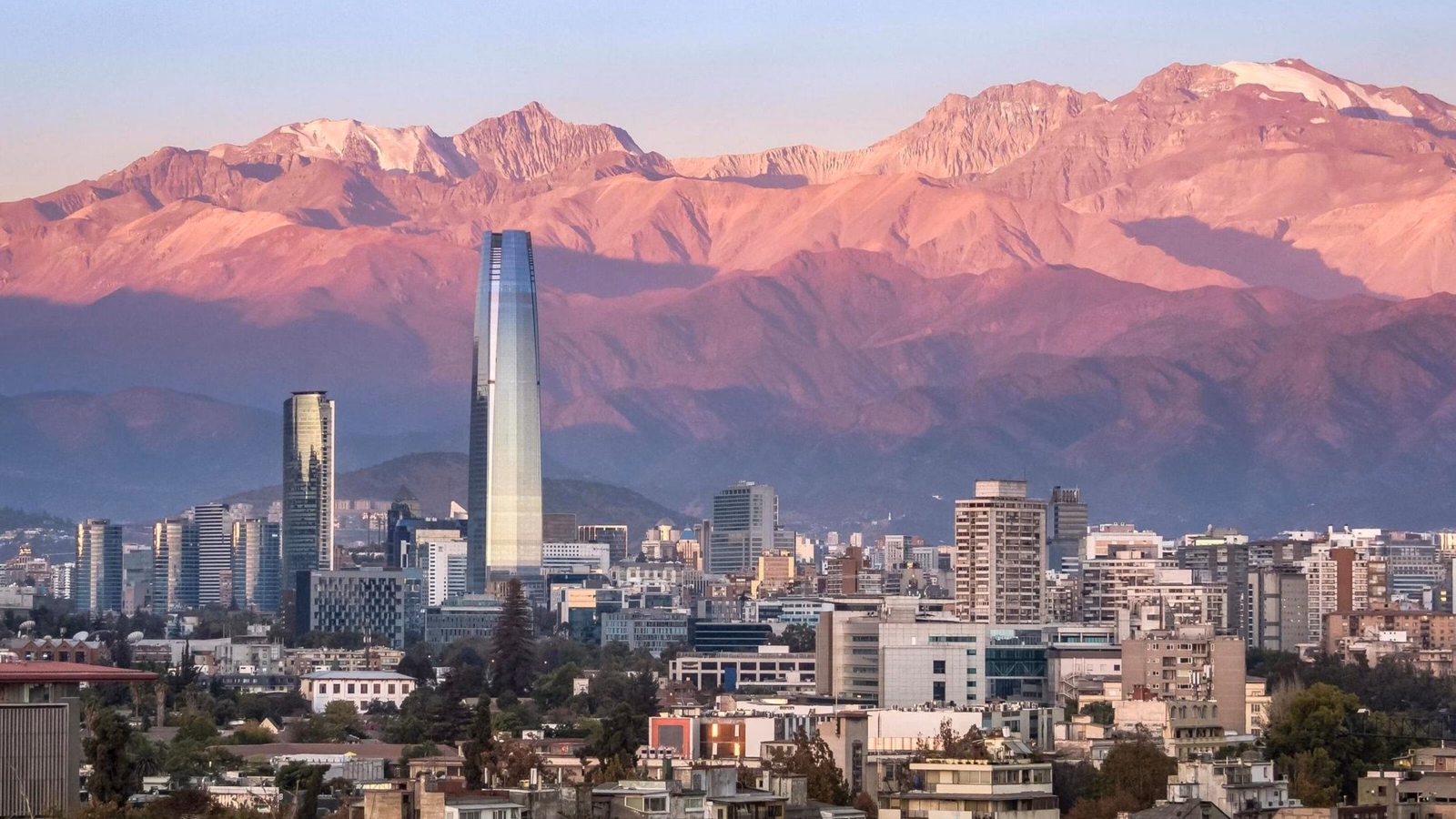 The skyline of Santiago, Chile at sunset, with mountains in the background