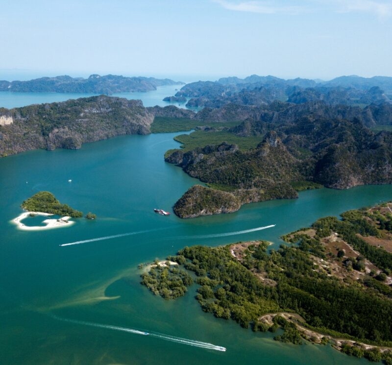 Aerial view of green islands and turquoise water channels explored on luxury Malaysia tours.