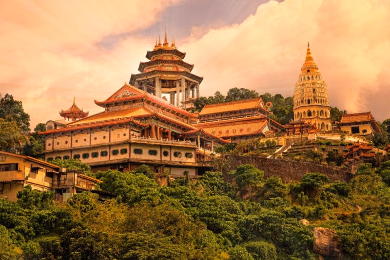 The ornate Kek Lok Si Temple complex sits on a lush hillside during luxury Malaysia vacations.