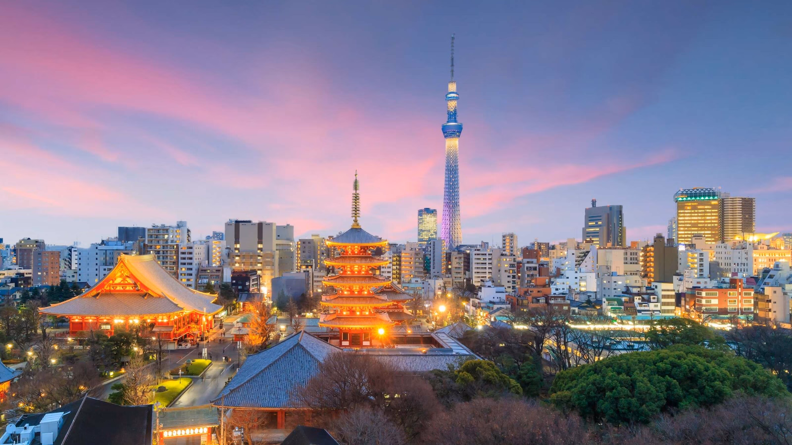 Tokyo skyline at dusk with Tokyo Skytree and traditional pagoda illuminated, under a pink sky.