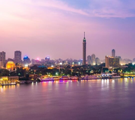 View of Nile river with El Gezira, zamalek, cairo tower and towers illuminated at night