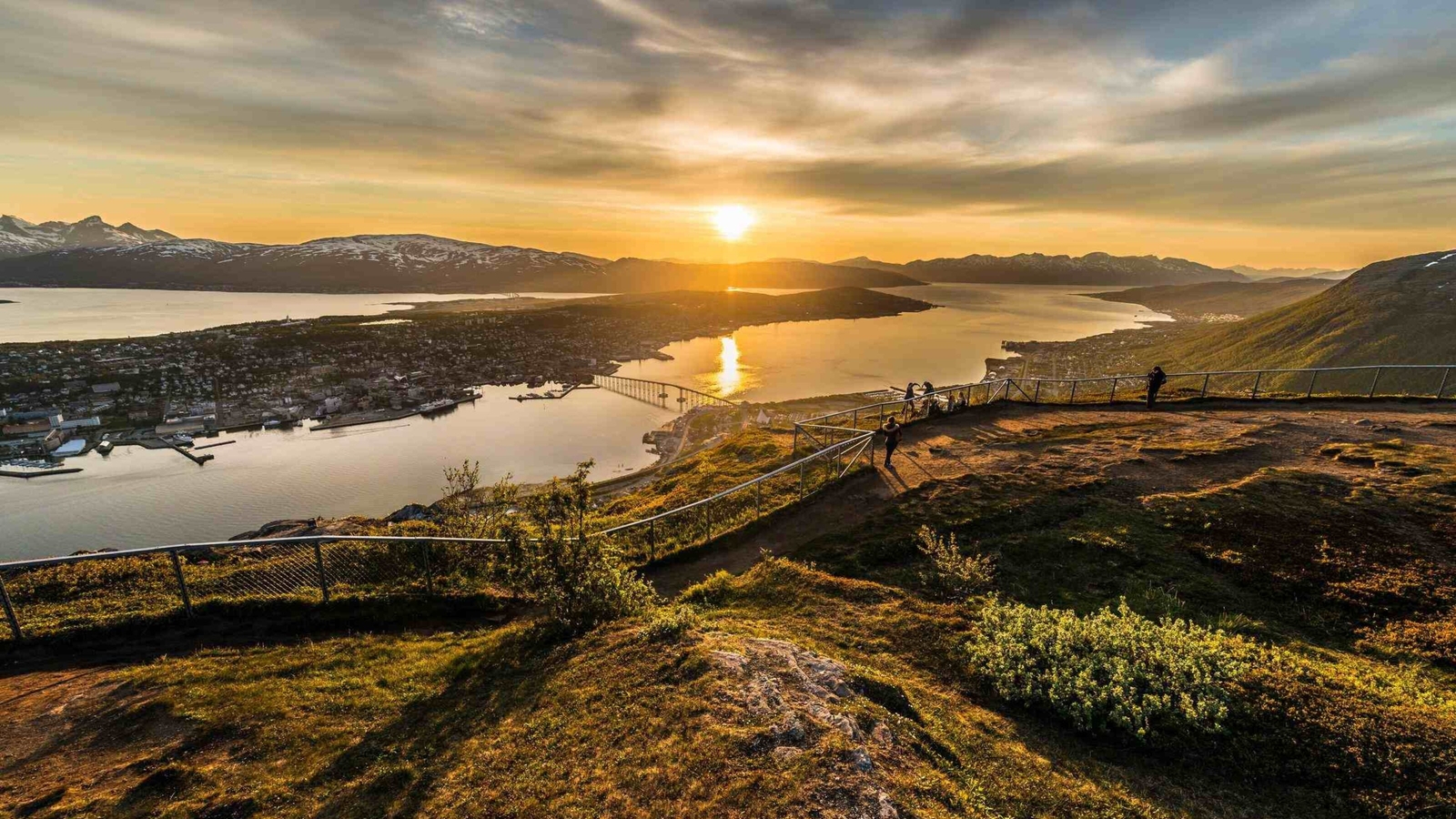 Tromso city in Tromsoya Island as seen from Mount Storsteinen under the Midnight Sun in Norway.