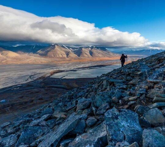 Hiking along the mountains - View over Longyearbyen and adventdalen fjord from above - the most Northern settlement in the world. Svalbard, Norway