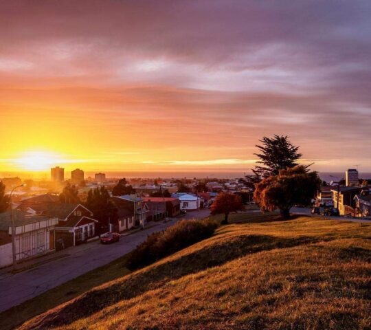 View over city towards Strait of Magellan at sunrise, Punta Arenas, Magallanes Province, Patagonia, Chile