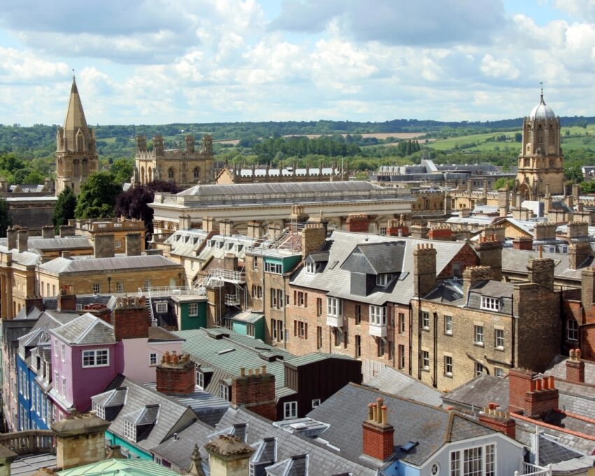 Aerial view of a historic cityscape with distinctive buildings and spires.