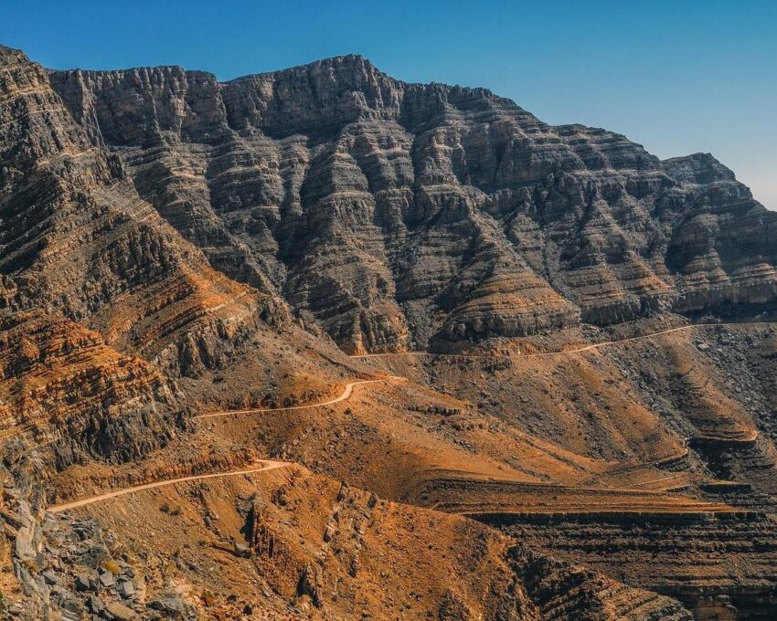A road winding through cliffs in the Musandam Peninsula, Oman
