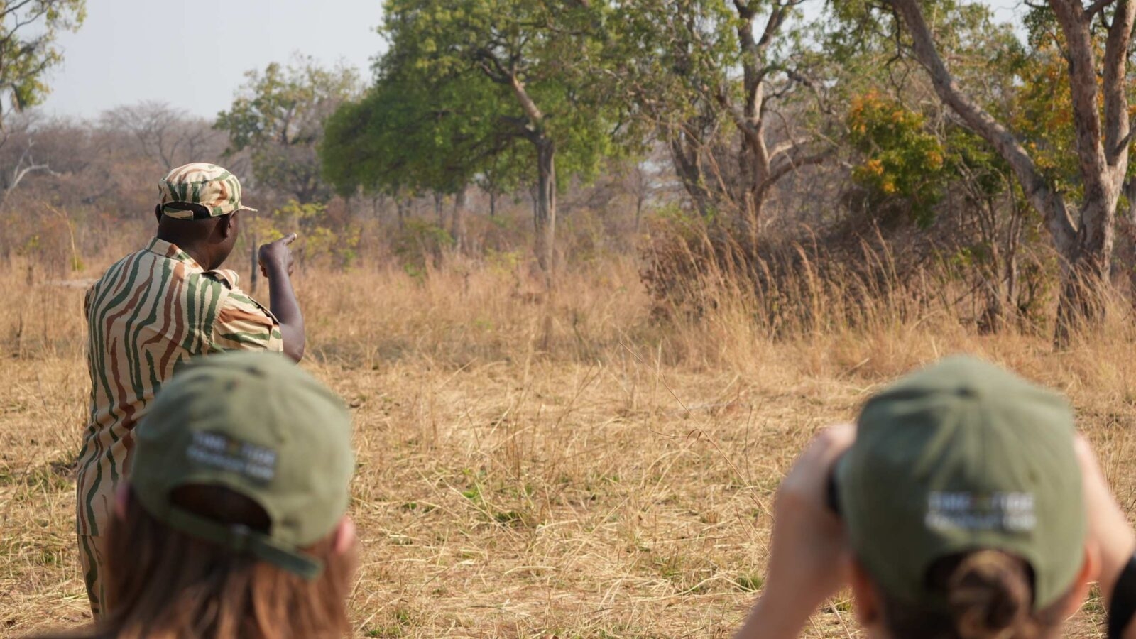 People with a guide on a walking safari in Zambia