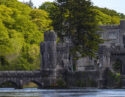 Ashford castle with stone bridge, river and forest