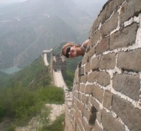 Section of the Great Wall of China overlooking mountainous terrain.