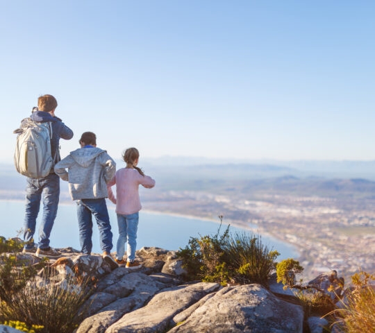 Family with two kids enjoying breathtaking views of Cape Town from top of Table mountain