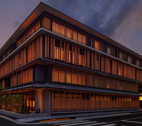 Modern building with traditional Japanese design elements at dusk.