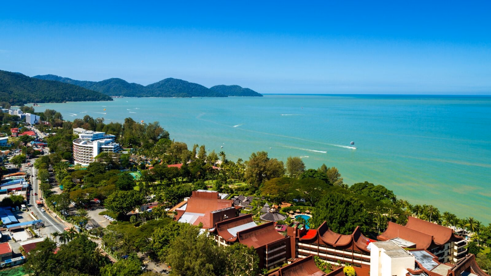 Batu Ferringhi beach on Penang Island, Malaysia with a clear blue sky in the daytime