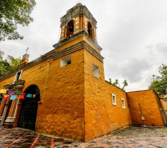 Church of Santa Catarina (Iglesia de Santa Catarina). A 16th century, bright yellow, baroque church in the Coyoacan district of Mexico City.