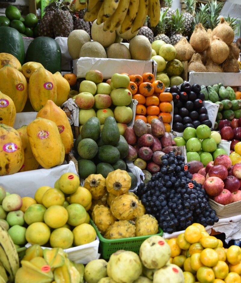 Assorted colorful tropical fruits displayed at a market stall.