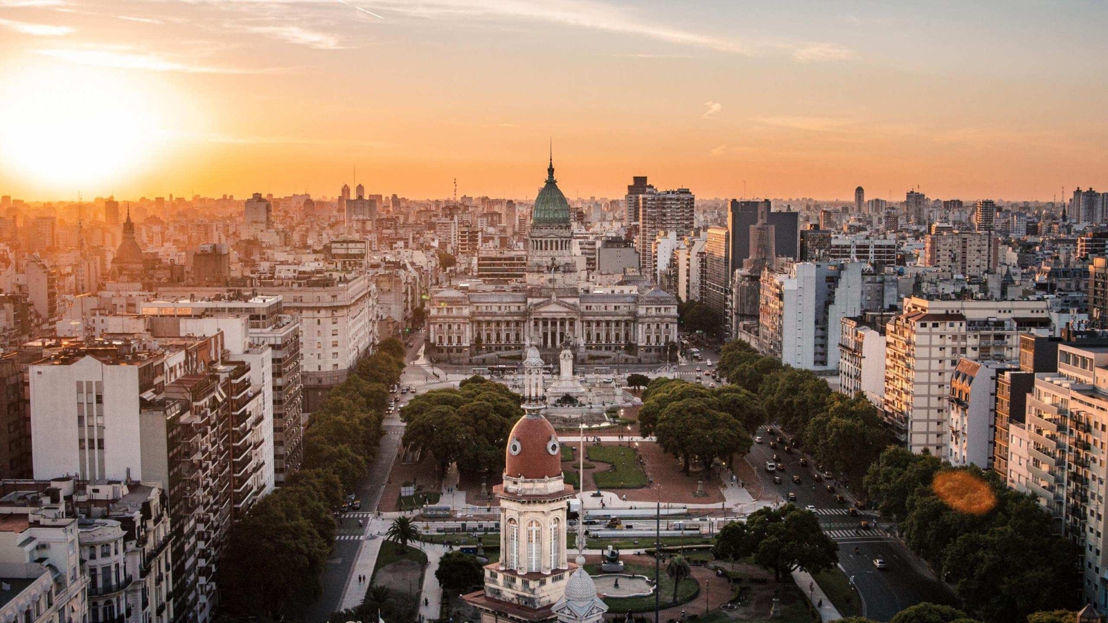 Aerial view of Buenos Aires cityscape at sunset with Congress building in focus.