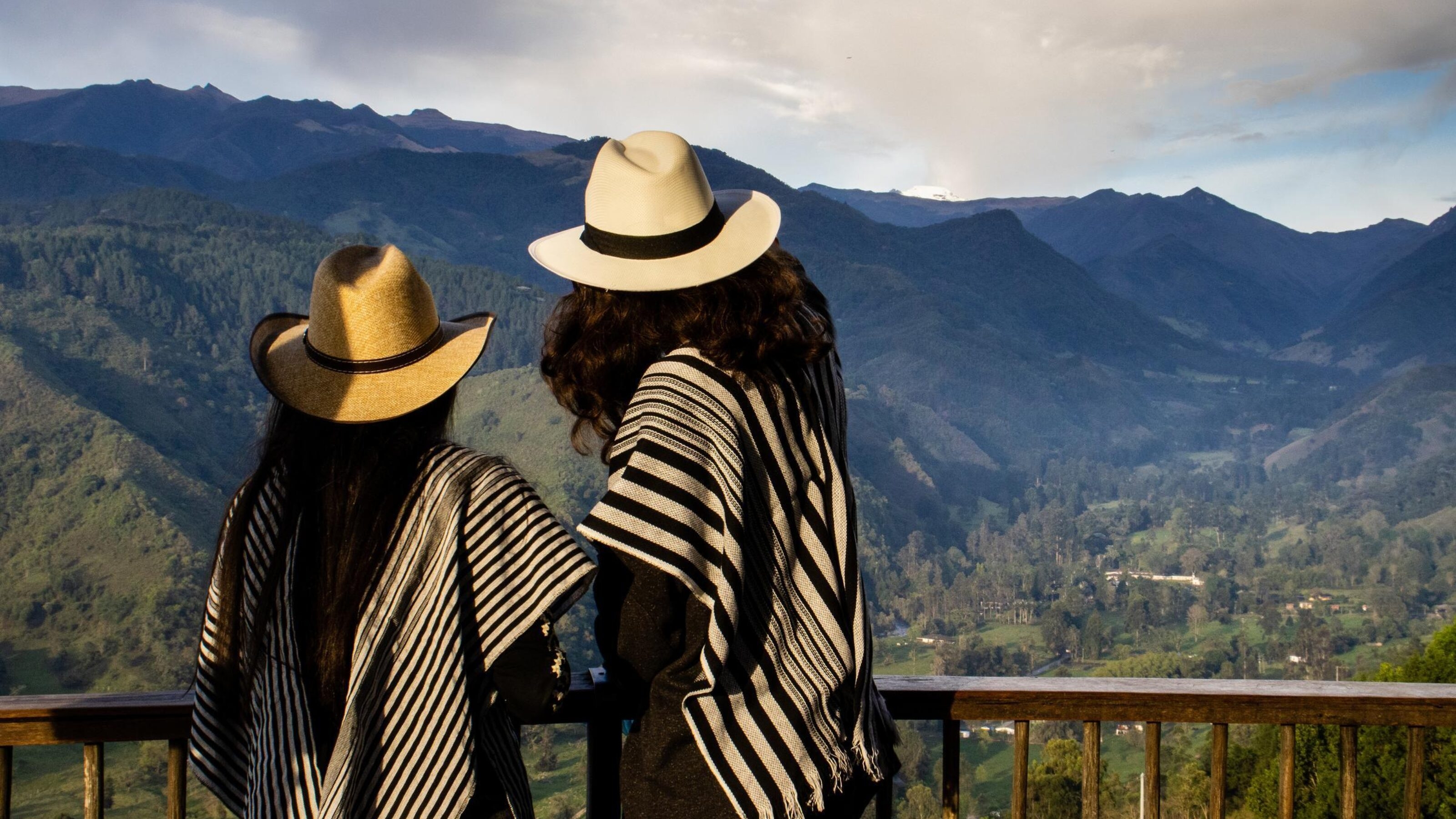 Couple of young tourists at the beautiful view point over the Cocora Valley at Salento, located on the region of Quindio in Colombia