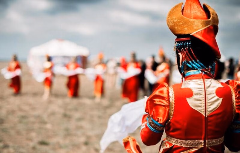 Photo of young beautiful women wearing in traditional national mongolian kalmykian dresses in the festival Photo of young beautiful women wearing in traditional national mongolian kalmykian dresses in the festival. yurt, nomad, mongolian, woman, culture, accessories, asia, beads, century, city, clothing, colorful, copy, costume, dance, decoration, detailed, dress, empire, ethnic, fashion, female, festival, folklore, genghis, girl, hat, khan, kalmykia, mongol, mongolia, national, native, outfit, people, space, style, symbol, symbolic, temple, traditional, unique, white, young, red, clouds, field, spring, early Mongolia