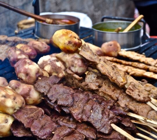 Grilled meat on skewers with potatoes in Peru