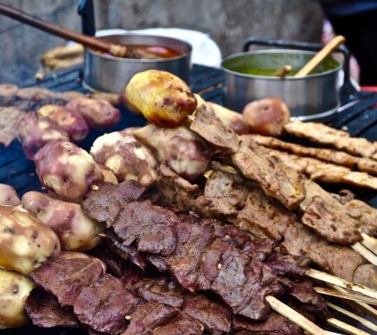Grilled meat on skewers with potatoes in Peru