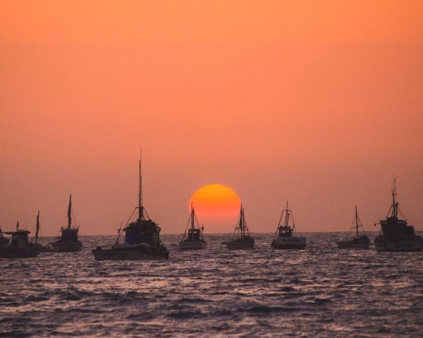 Fishing boats on the water at sunset in Mancora, Peru