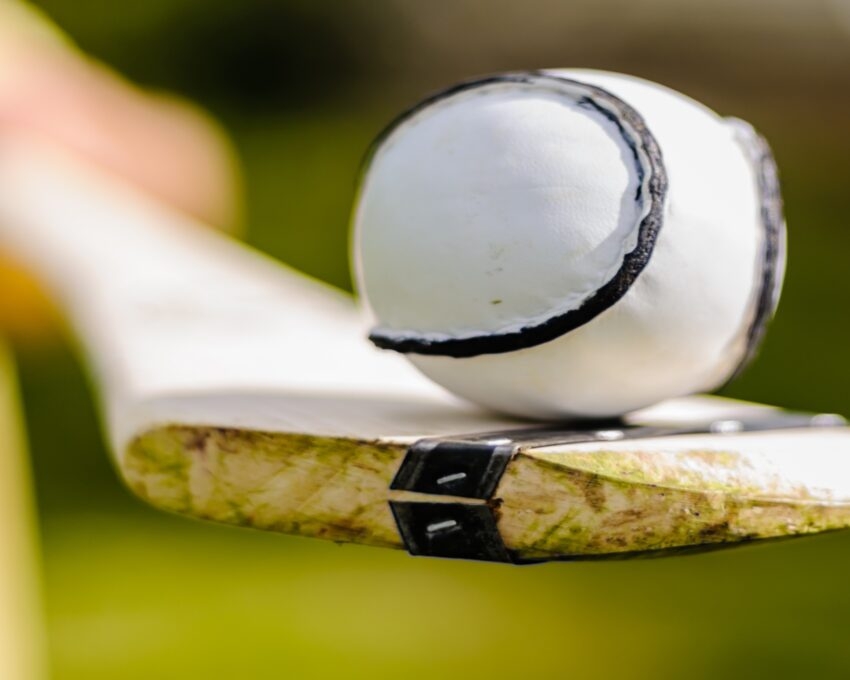 Close-up of a sloitar ball on a bat with blurry background.
