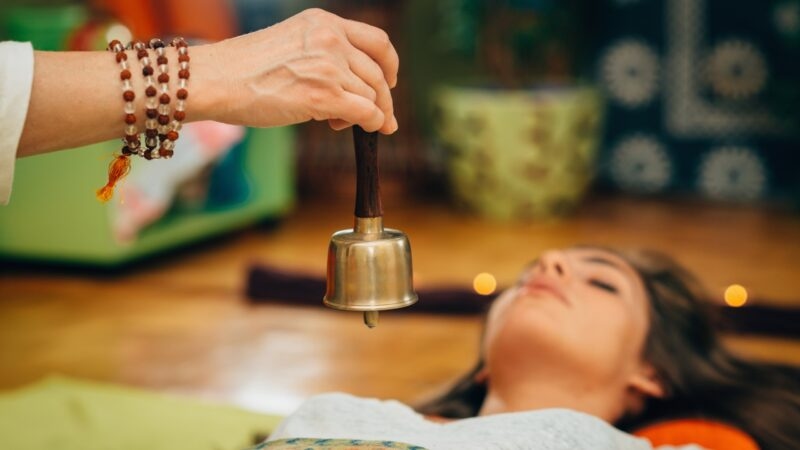 A woman receiving a massage indoors, with a focus on her relaxed facial expression.
