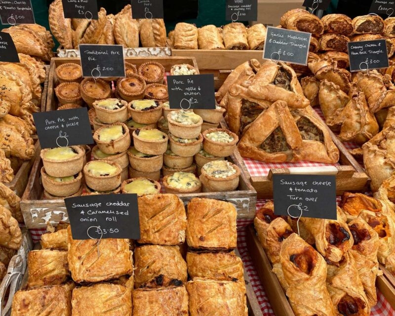 A market stall selling pies and savoury bakes in Malton, North Yorkshire